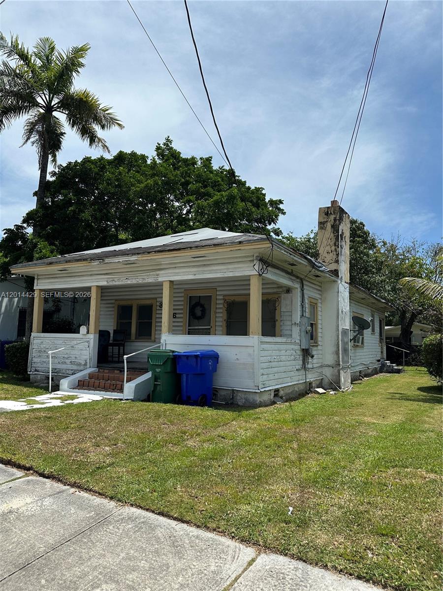 A single-story white house with a front porch and a chimney stands on a lawn — 3566 Thomas Ave, Miami FL 33133, MIAMI, FL
