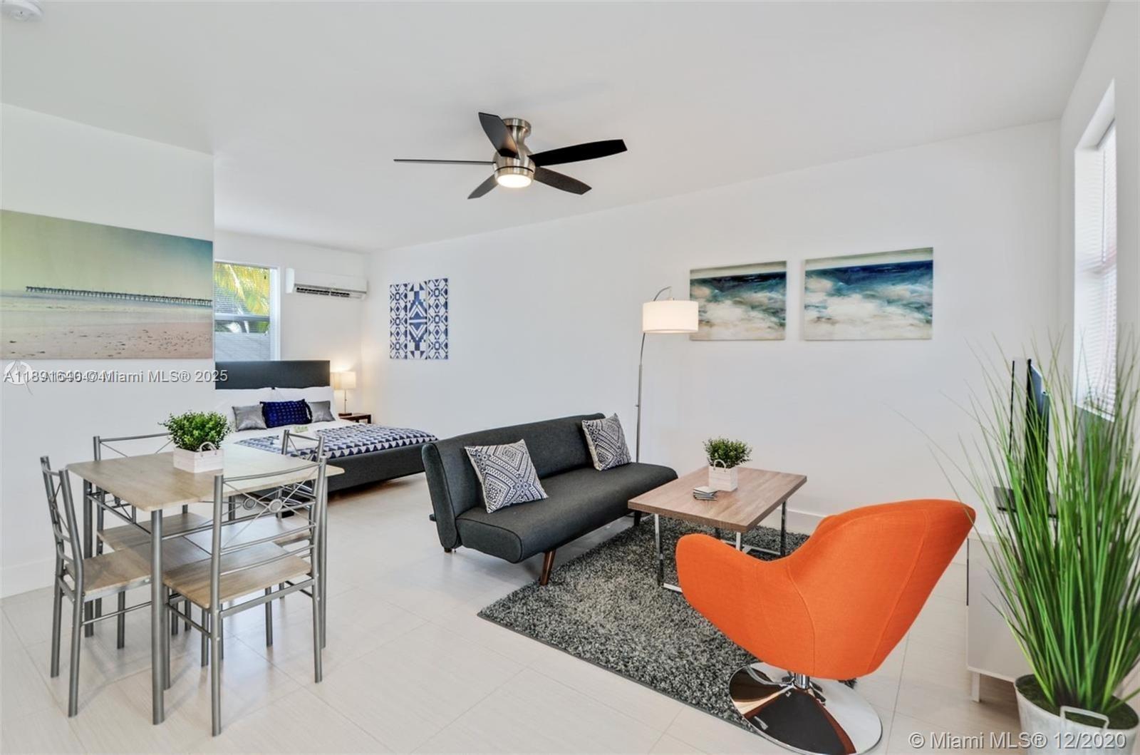 This studio apartment features a dining area, a living space with a sofa, and a bed — 2601 NW 1st Ave # 4, Miami FL 33127, MIAMI, FL