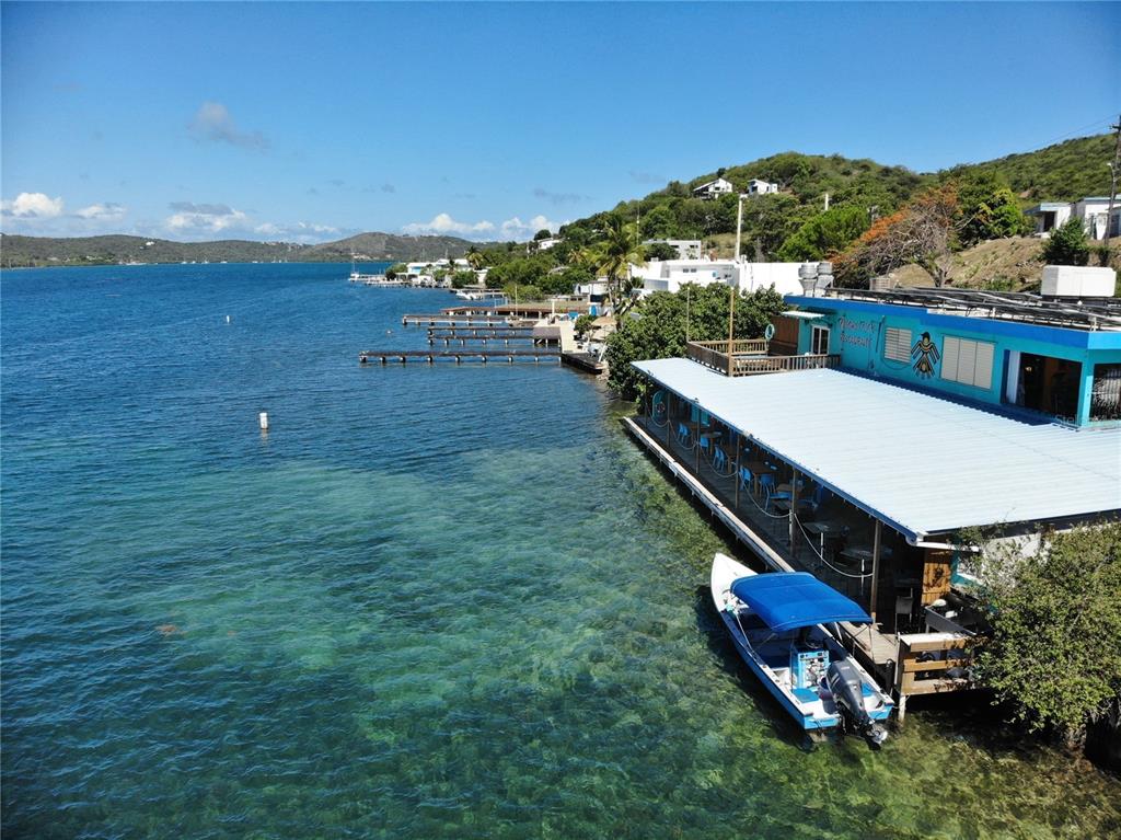 An aerial view shows a waterfront restaurant with a boat docked alongside a wooden deck — 372 CALLE FULLADOZA, CULEBRA, PR