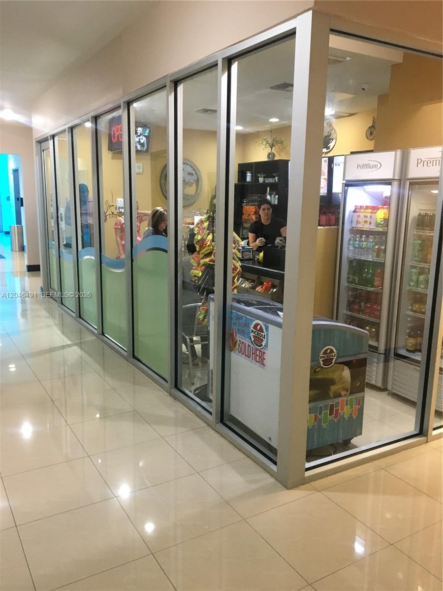 A small cafe interior is visible through a glass-walled storefront with tiled floors — 2300 W 84th St # 104, Hialeah FL 33016, HIALEAH, FL