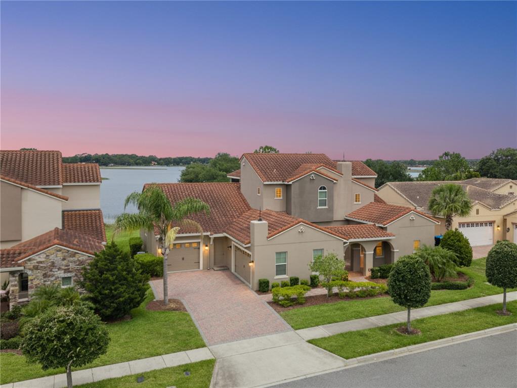 An aerial view of a two-story stucco house with a tile roof and lakefront backyard — 8750 BAYVIEW CROSSING DRIVE, WINTER GARDEN, FL