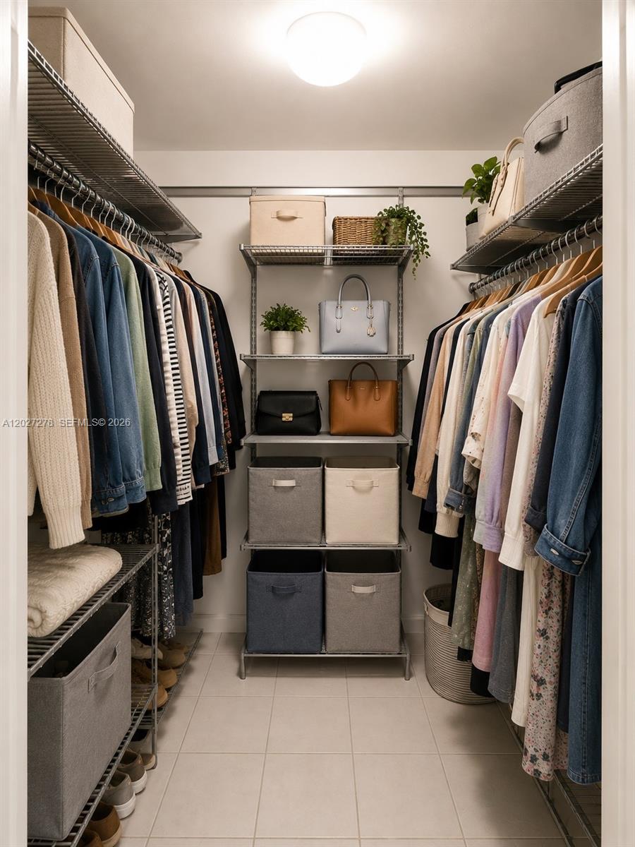 A walk-in closet features wire shelving, hanging clothes, and organized storage bins and handbags — 901 NE 2nd St, Hallandale Beach FL 33009, HALLANDALE BEACH, FL