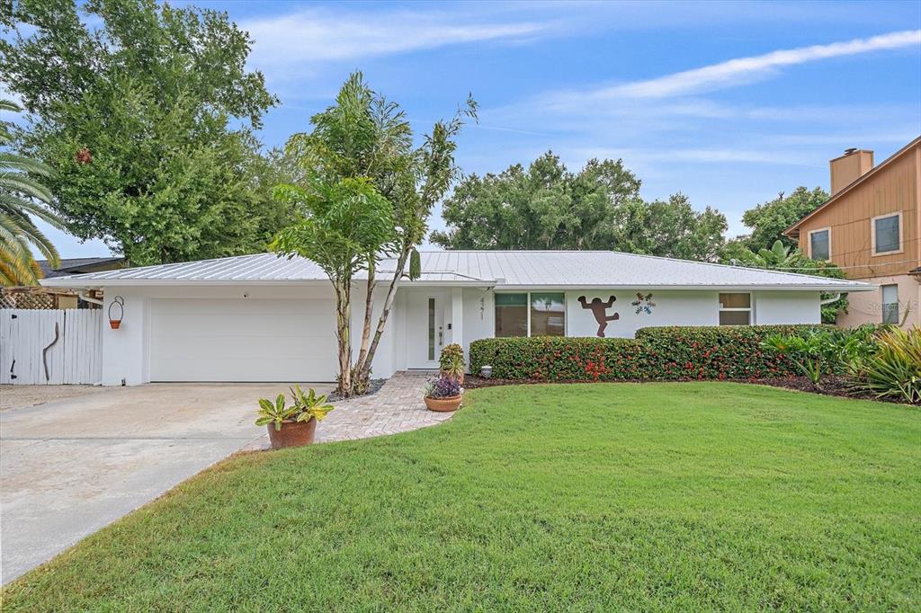An aerial view of a waterfront house with a large lawn and two wooden docks — 4271 LAGO WAY, SARASOTA, FL