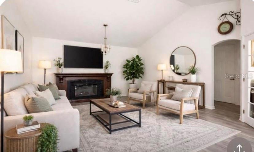 A living room features a fireplace, a coffee table, two armchairs, and a sofa — 20851 SW 36TH STREET, DUNNELLON, FL