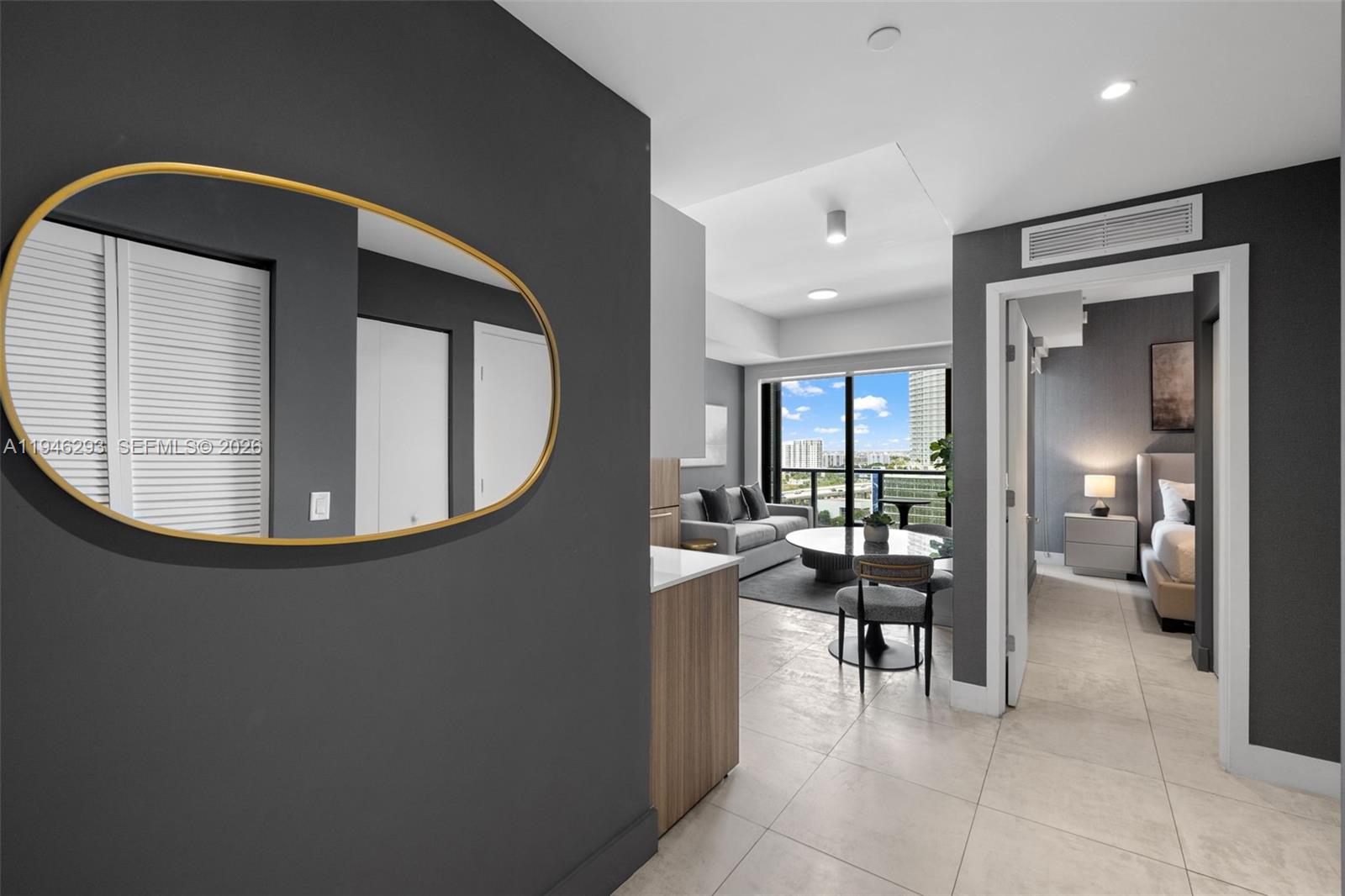 A view from a hallway into a modern apartment living area with a bedroom adjacent — 239 SW 9th St # 1604, Miami FL 33130, MIAMI, FL
