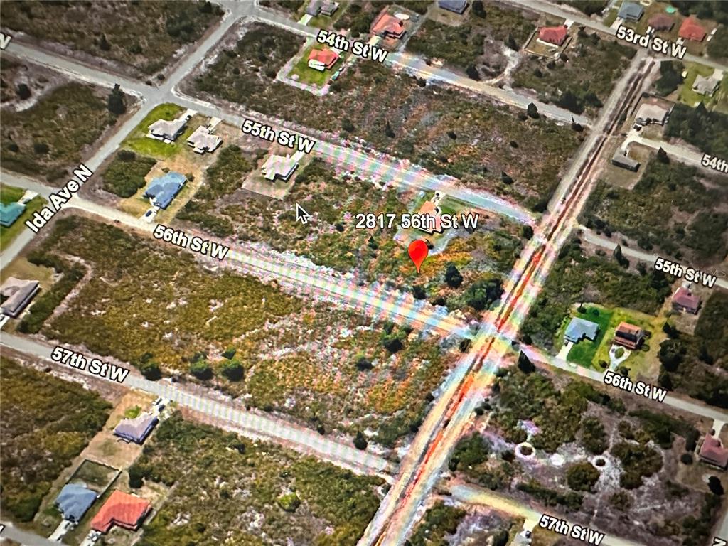 This aerial map shows a vacant lot with a red location pin — 2817 56TH STREET W, LEHIGH ACRES, FL