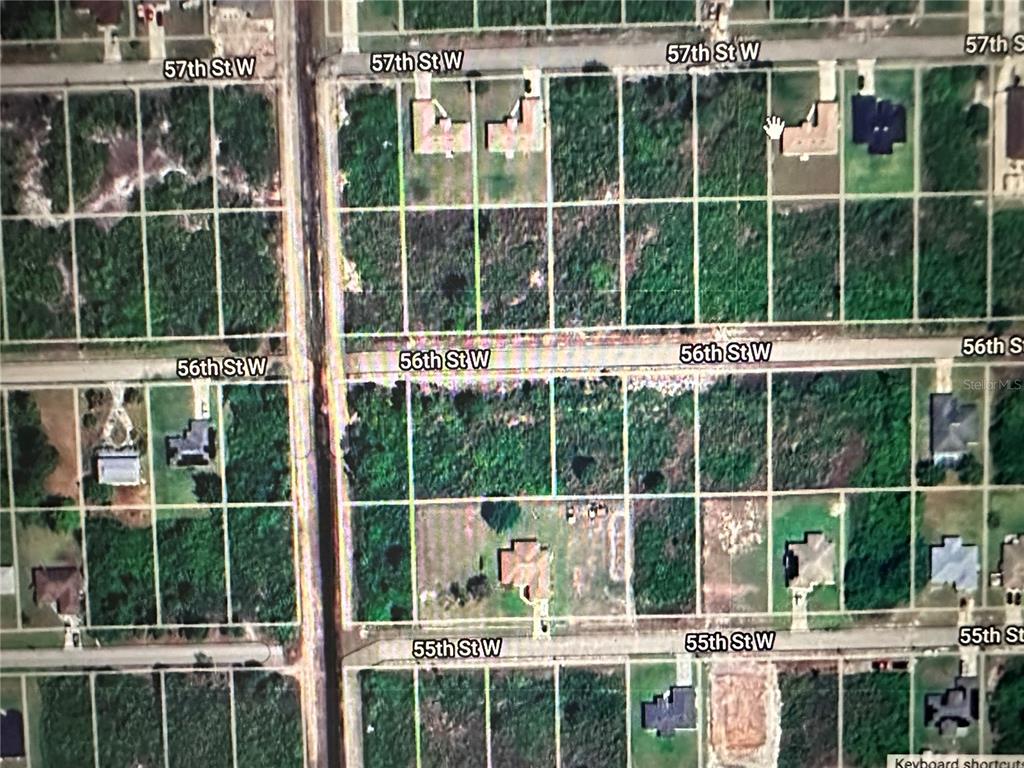 An aerial map view showing residential lots, streets, and scattered houses in a wooded area — 2817 56TH STREET W, LEHIGH ACRES, FL
