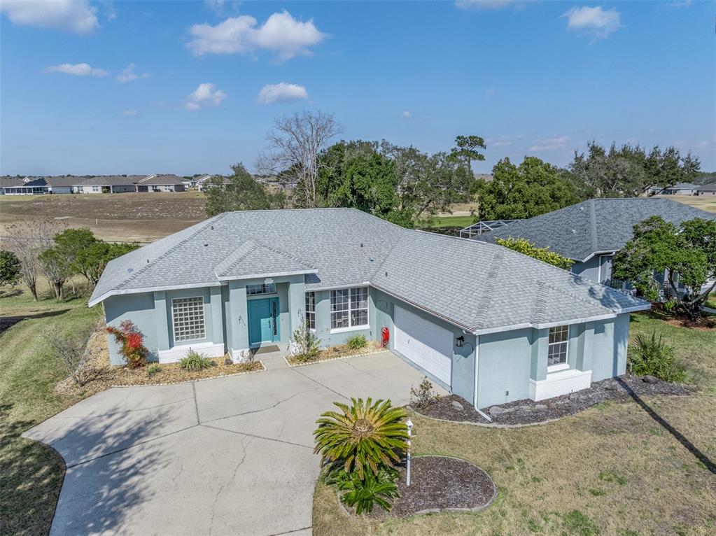 An aerial view of a single-story house with a light blue exterior and gray roof — 4740 N CRESTLINE DRIVE, BEVERLY HILLS, FL