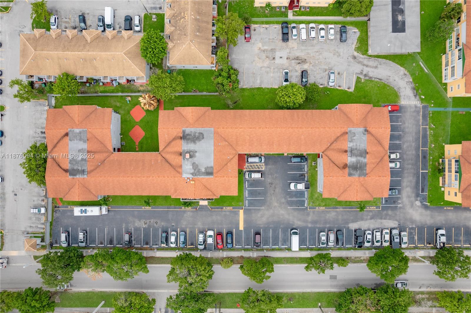 An aerial view shows an apartment complex with parking lots and surrounding green space — 120 Royal Palm Rd # 315, Hialeah Gardens FL 33016, HIALEAH GARDENS, FL