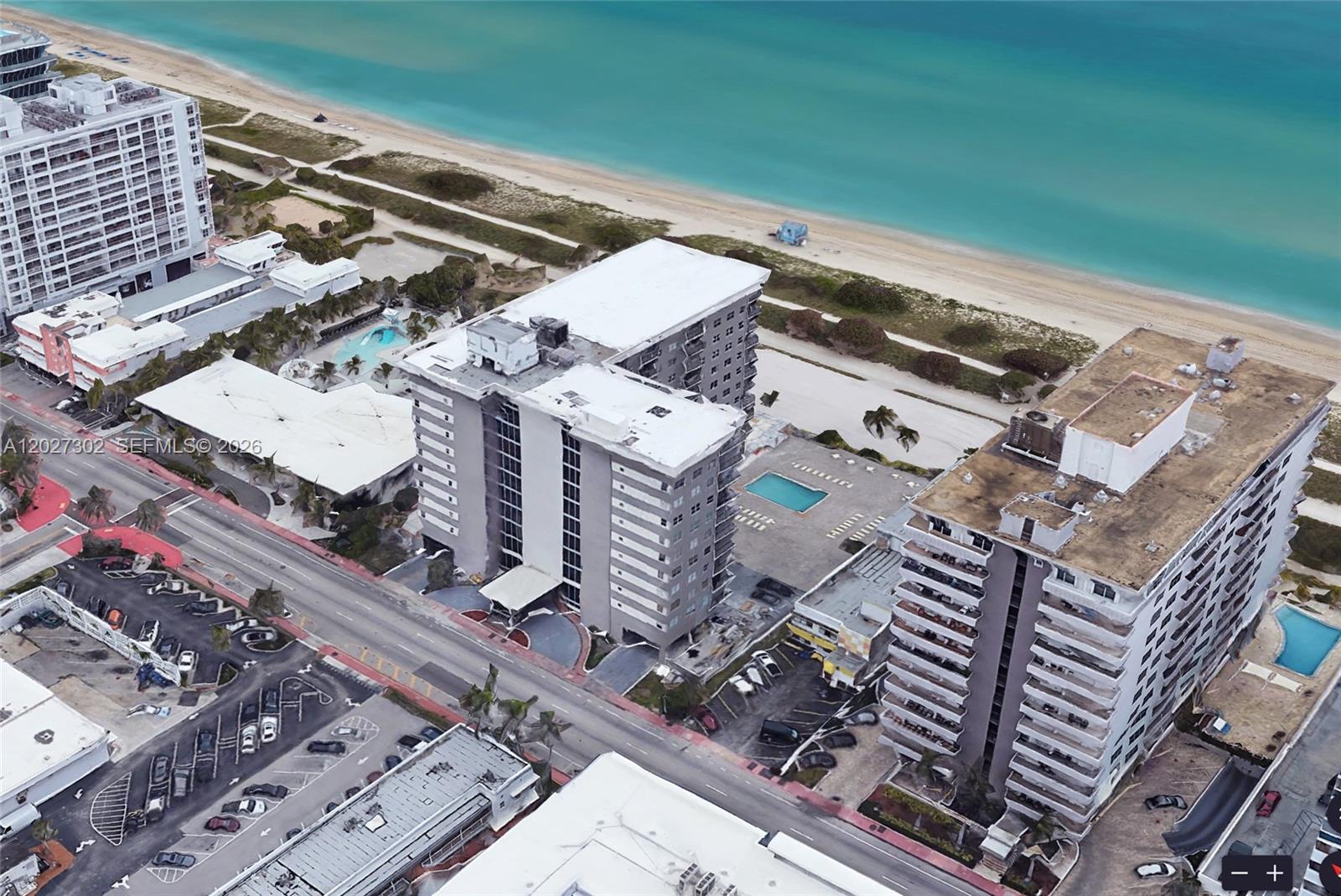 An aerial view shows several multi-story apartment buildings located directly along a sandy beach — 9273 Collins Ave # 506, Surfside FL 33154, SURFSIDE, FL