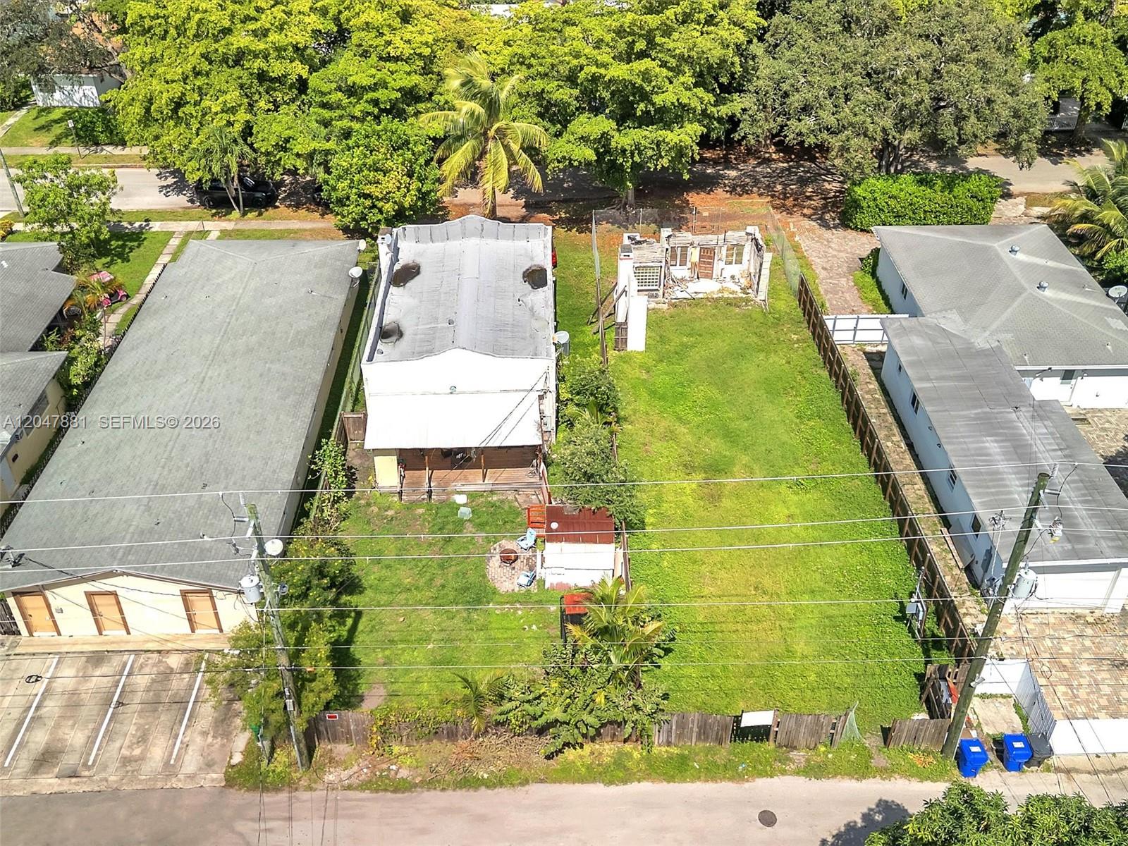 An aerial view shows a residential lot with a house and a ruined structure — 1932 Dewey St, Hollywood FL 33020, HOLLYWOOD, FL