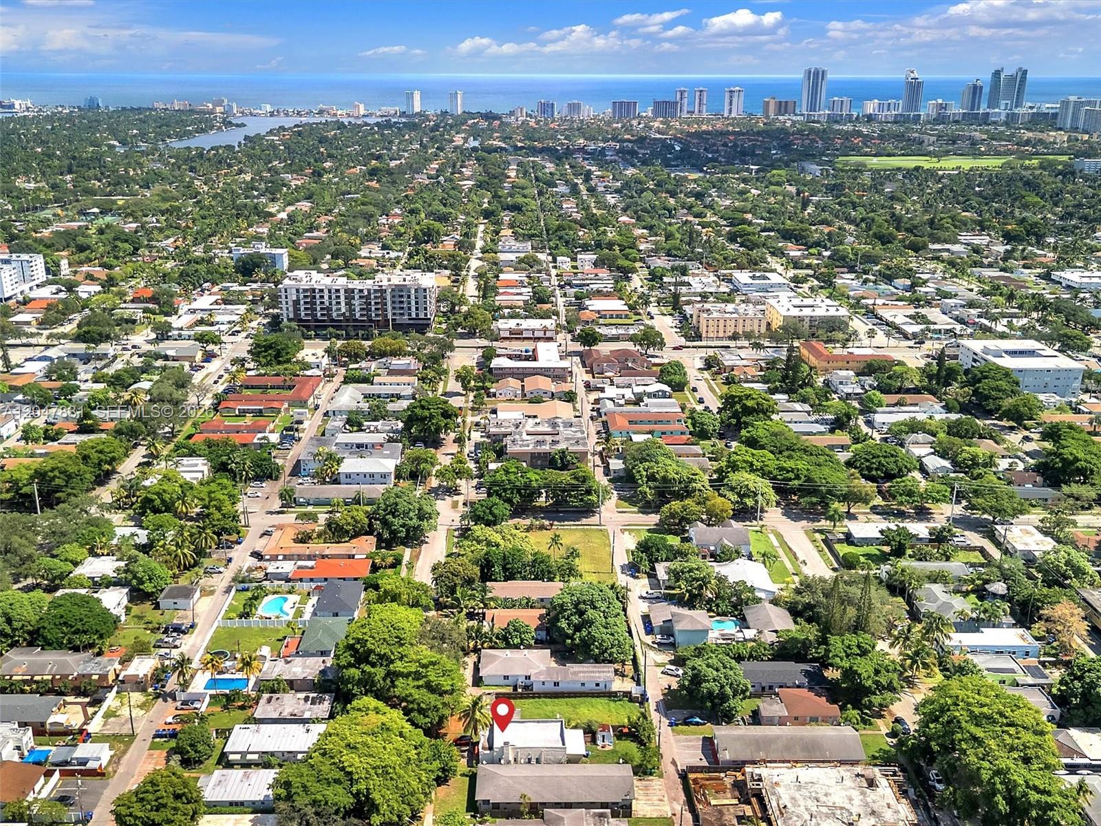 An aerial view shows a residential neighborhood with a red pin marking a specific property — 1932 Dewey St, Hollywood FL 33020, HOLLYWOOD, FL