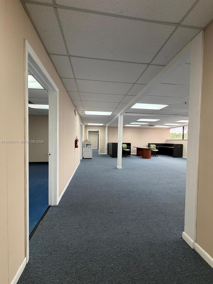 An office space features beige walls, blue carpeting, a drop ceiling, and a central pillar — 1355 NW 97 Avenue, Doral FL 33172, DORAL, FL