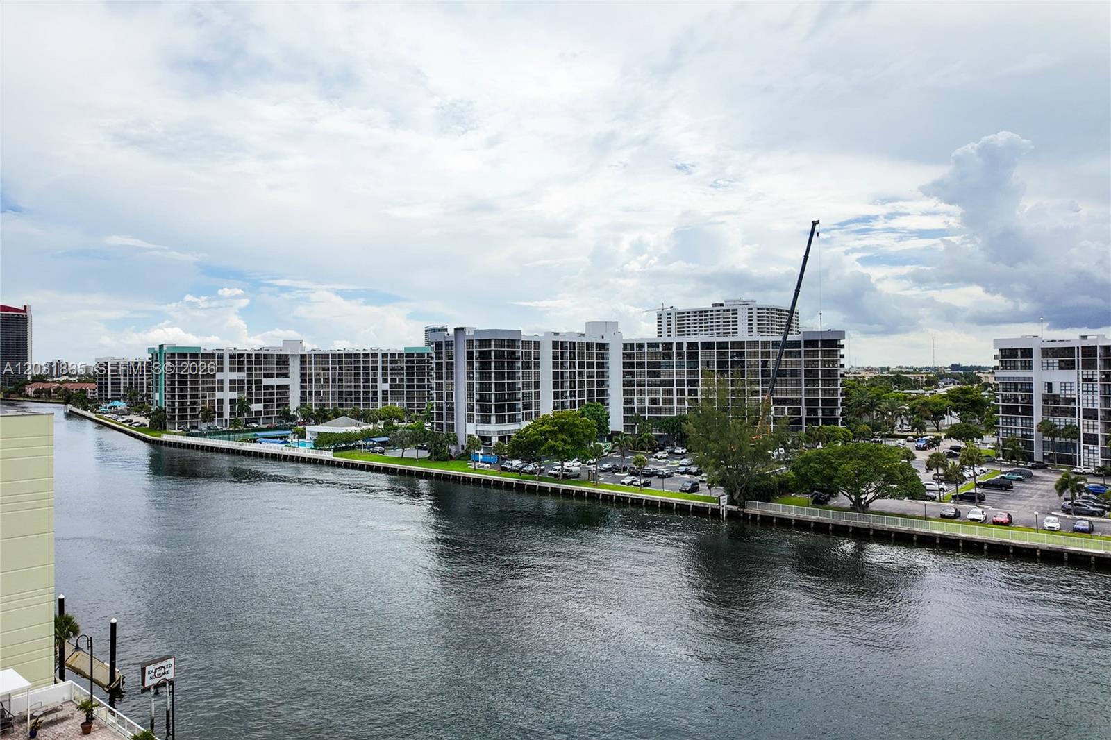 An elevated view of a canal lined with multi-story apartment buildings and parking lots — 3000 S Ocean Dr # 712, Hollywood FL 33019, HOLLYWOOD, FL