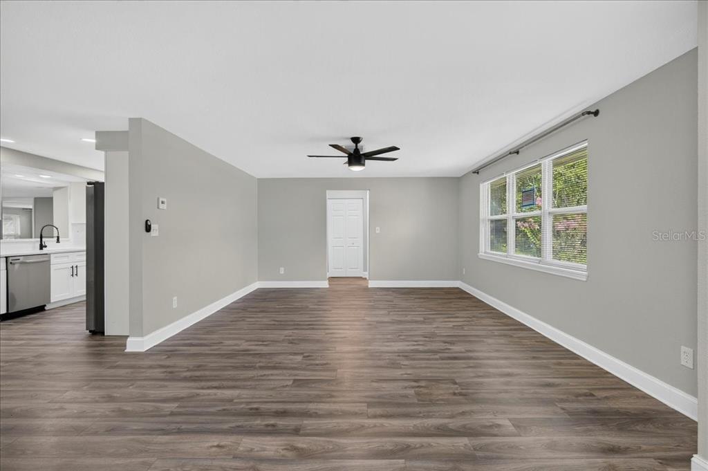 An empty room with light gray walls, wood-look flooring, a ceiling fan, and a window — 1779 UNION STREET, CLEARWATER, FL