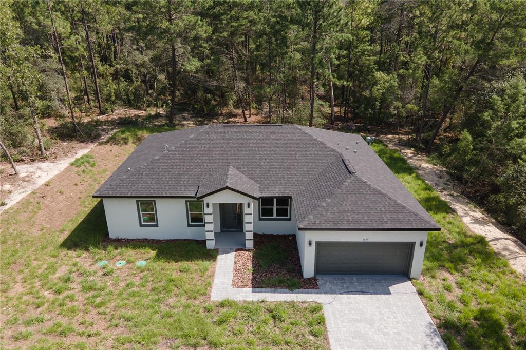 An aerial view of a single-story house with a gray roof and white exterior walls — 3691 W NORWICK PLACE, DUNNELLON, FL