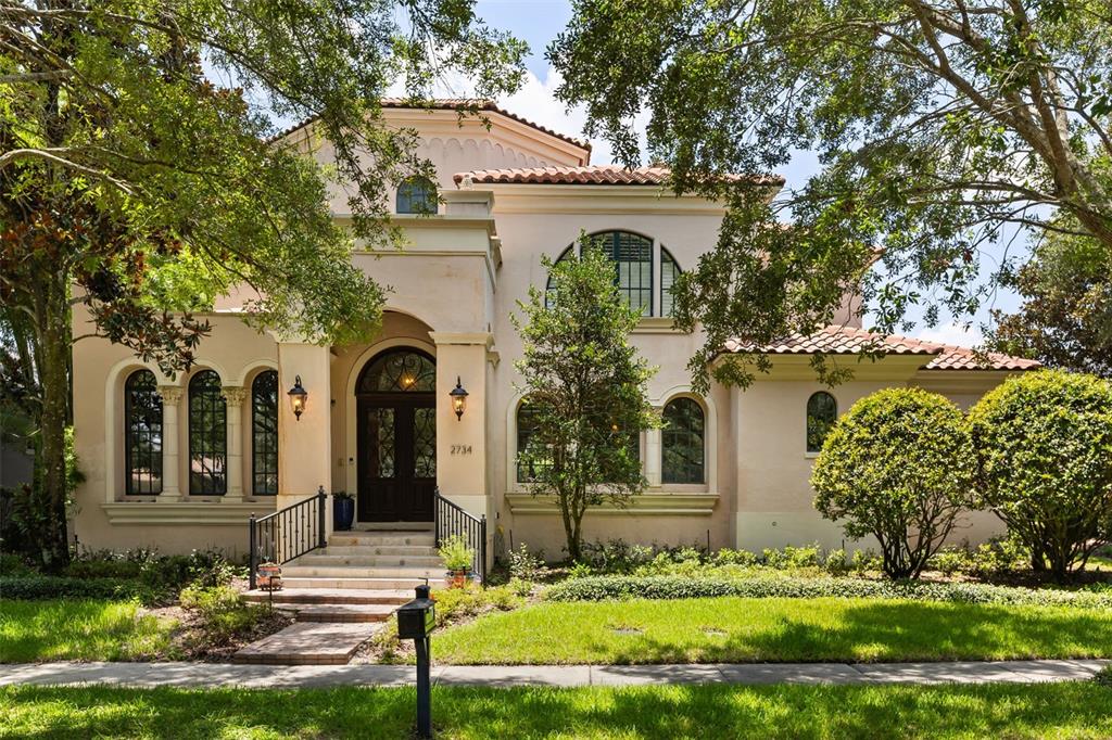 A two-story Mediterranean-style house features a tiled roof, arched windows, and a front entryway — 2734 MEETING PLACE, ORLANDO, FL