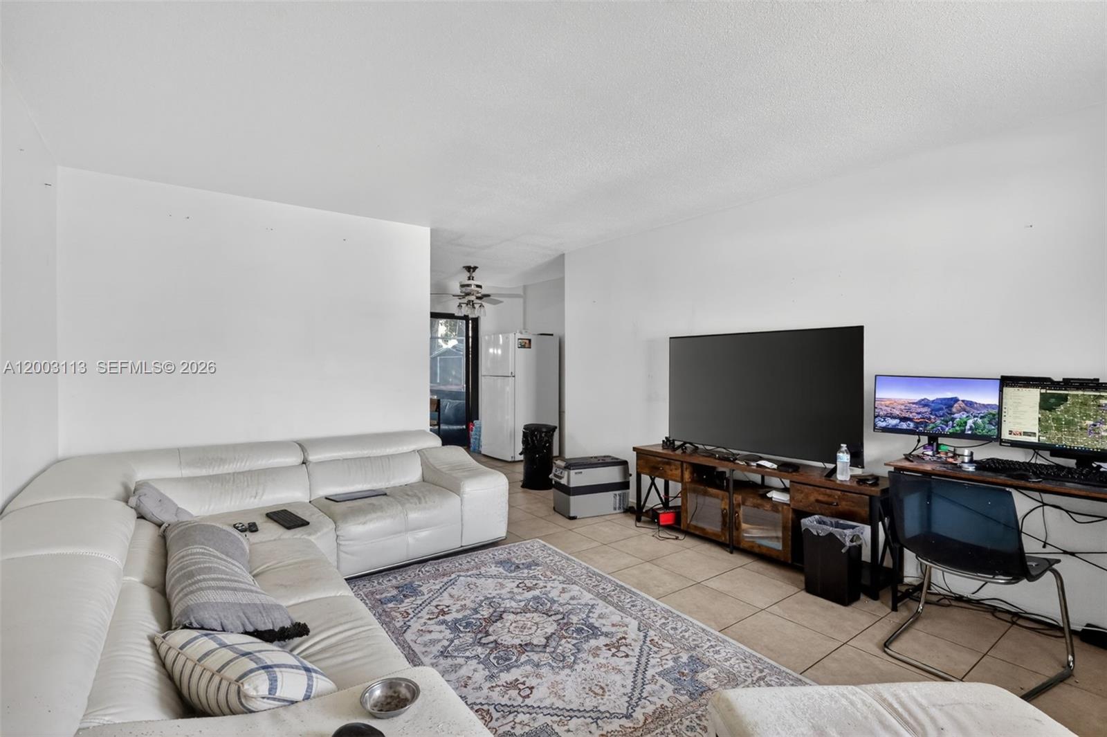 A living room features a white sectional sofa, a television console, and a computer desk — 5814 Cleveland St, Hollywood FL 33021, HOLLYWOOD, FL
