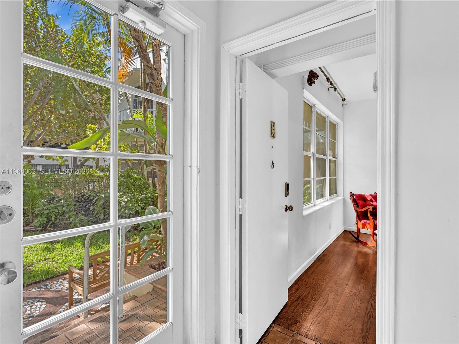 A white door opens from a glass-paned entryway into a room with wood flooring — 503 12th St # 5, Miami Beach FL 33139, MIAMI BEACH, FL