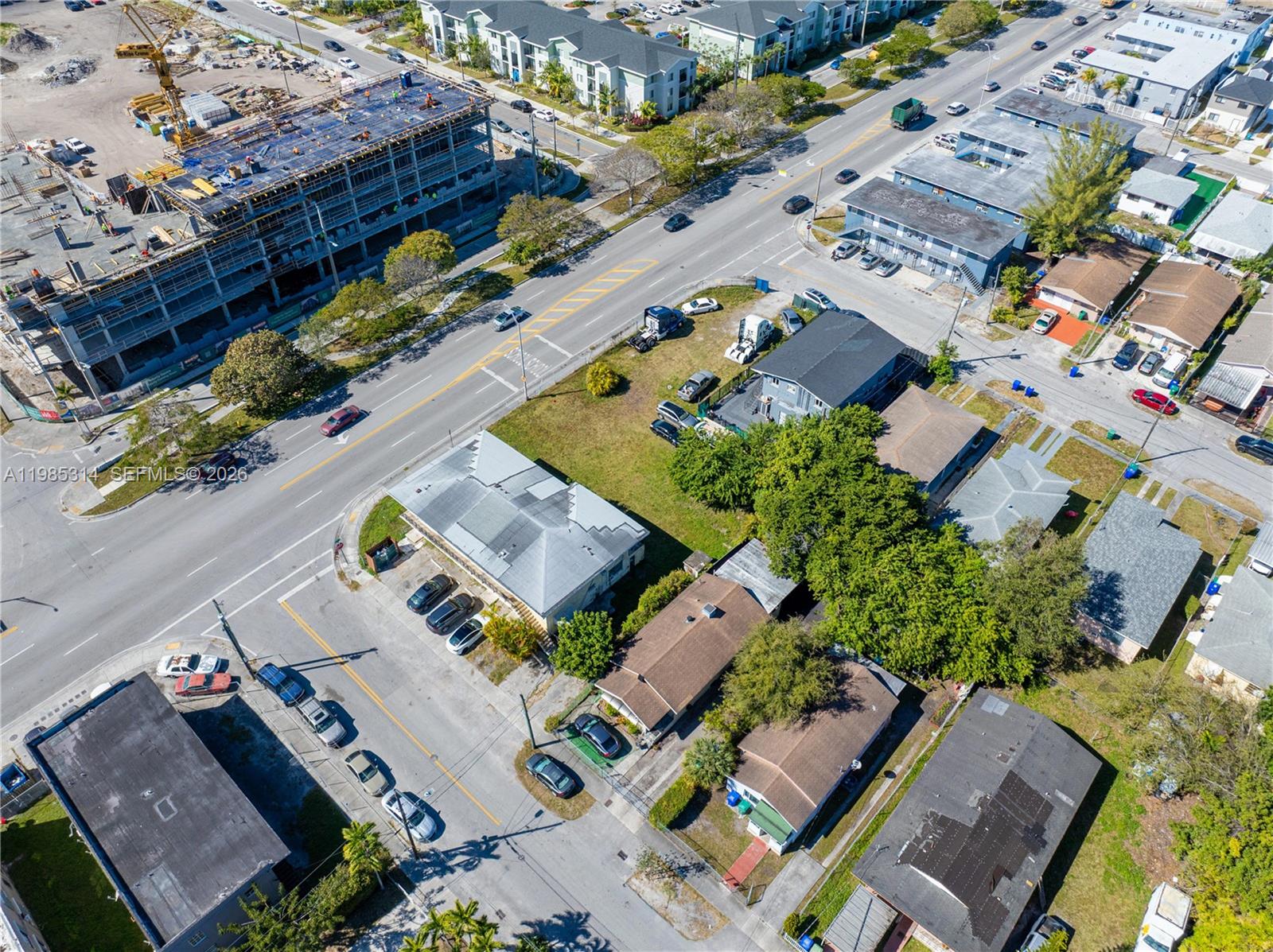 An aerial view shows a city street with a construction site and residential buildings — 6401 NW 12th Ave, Miami FL 33150, MIAMI, FL
