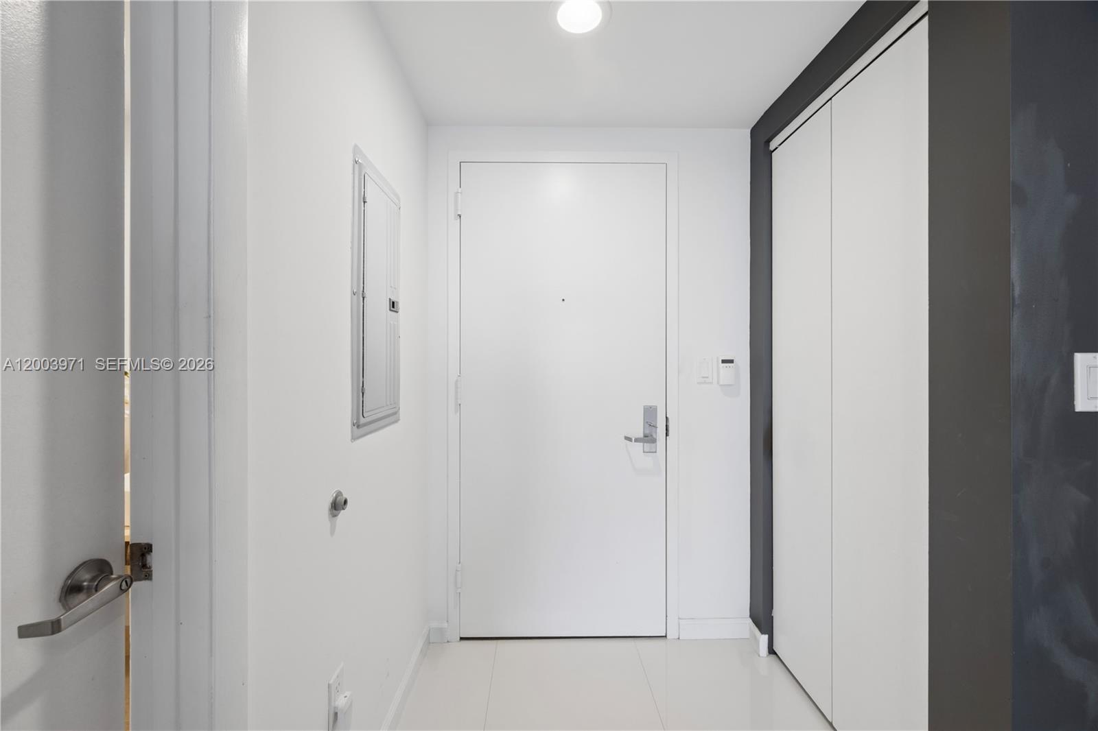 A white entryway features a front door, a closet, and a wall-mounted electrical panel — 465 Brickell Ave # 3804, Miami FL 33131, MIAMI, FL