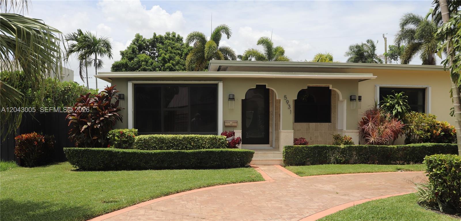 A single-story house with a flat roof, arched entryway, and a paved driveway — 5931 SW 46th St, Miami FL 33155, MIAMI, FL