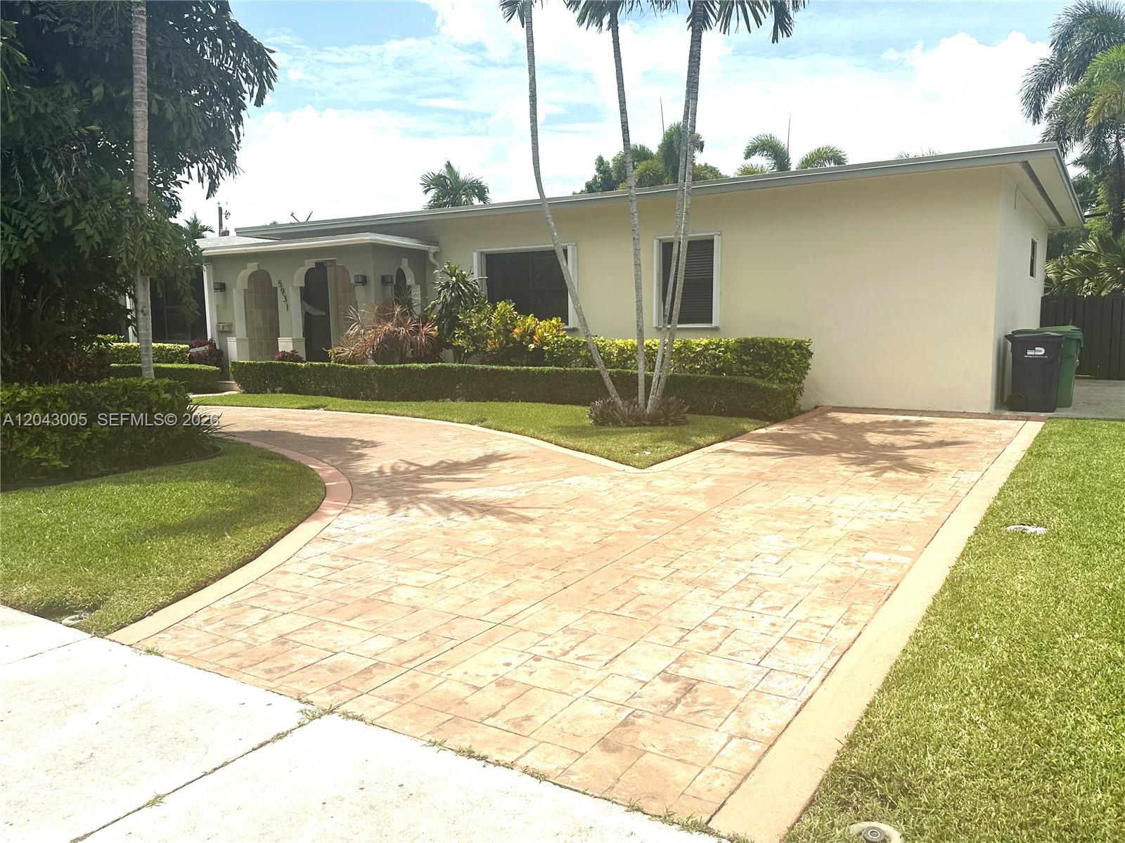 A single-story house features a stamped concrete driveway, manicured hedges, and tall palm trees — 5931 SW 46th St, Miami FL 33155, MIAMI, FL