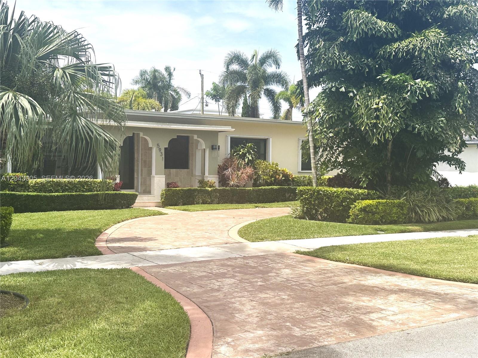 A single-story house features a curved paved driveway, manicured hedges, and tropical landscaping — 5931 SW 46th St, Miami FL 33155, MIAMI, FL