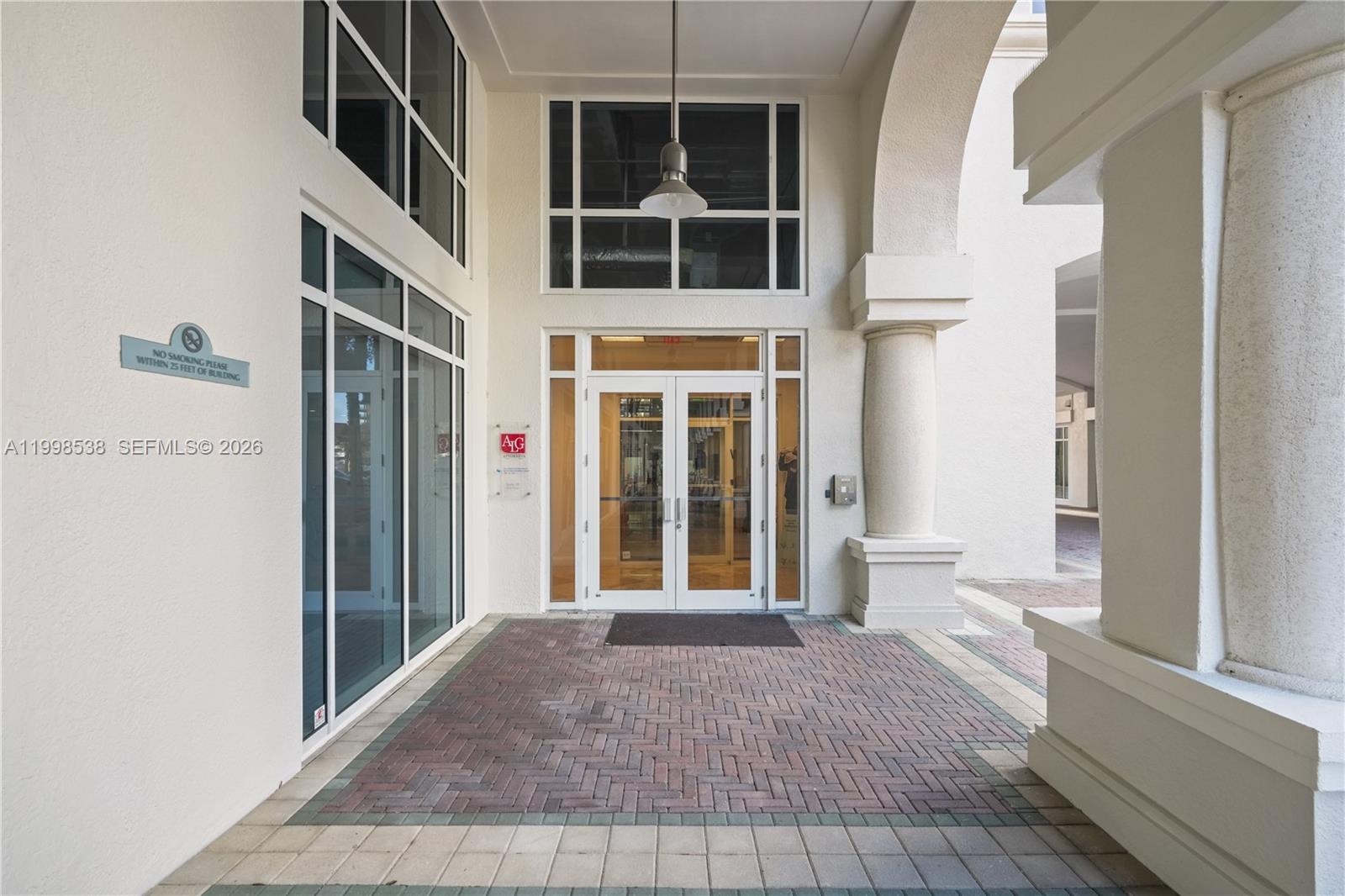 The exterior entrance features double glass doors, a brick walkway, and decorative columns — FORT LAUDERDALE, FL