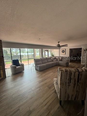 A living room features wood-look tile flooring, a large sectional sofa, and floor-to-ceiling windows — 1020 E MICHIGAN STREET UNIT 1020, ORLANDO, FL