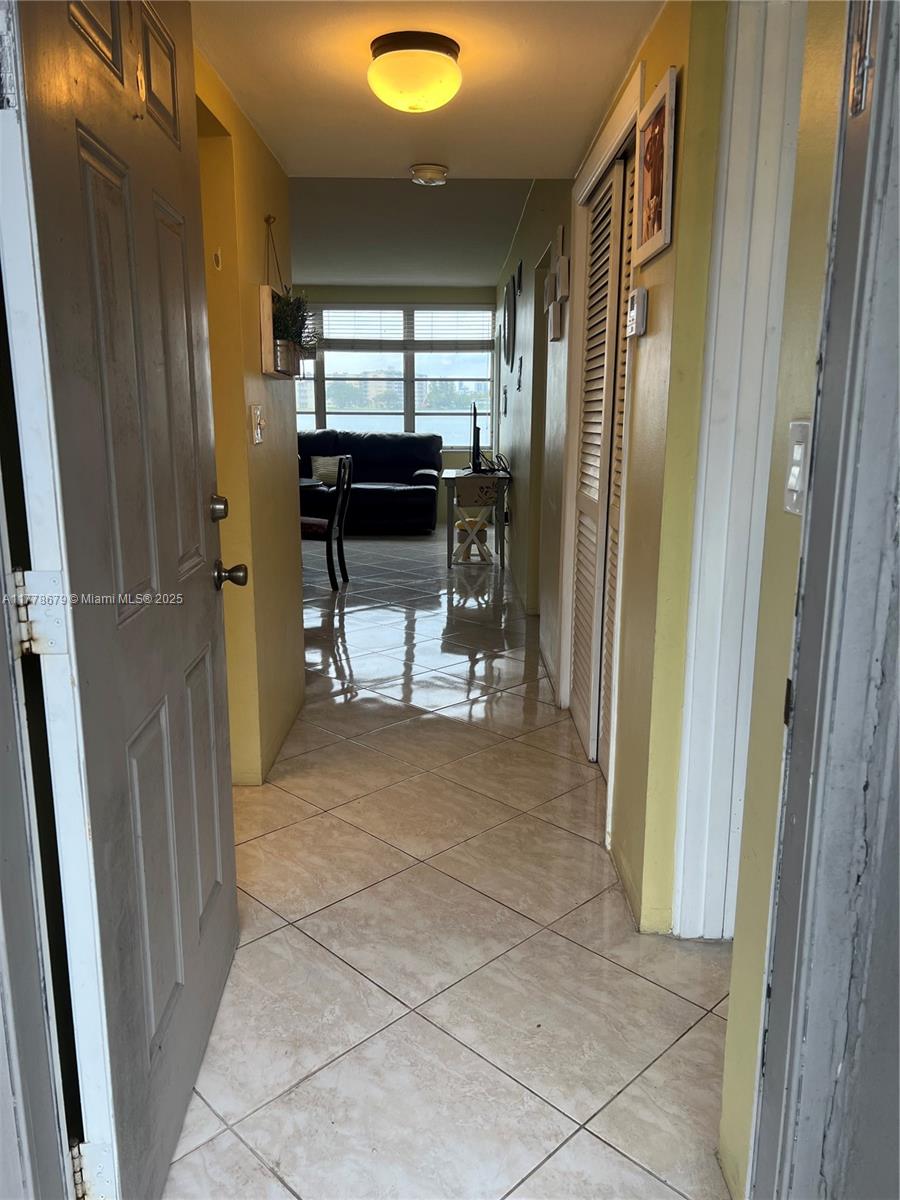 An entryway leads into a living area with tile floors and a view of water — 18555 NE 14th Ave # 516, Miami FL 33179, MIAMI, FL