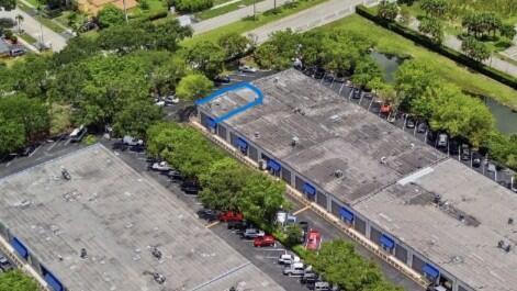 Aerial view of a commercial building complex with parking lots and surrounding trees — 10002 NW 46th Street # 10002, Sunrise FL 33351, SUNRISE, FL