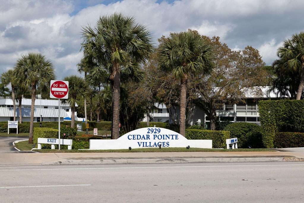 A sign for Cedar Pointe Villages stands in front of palm trees and residential buildings — 2929 SE Ocean Boulevard # 8, Stuart FL 34996, STUART, FL