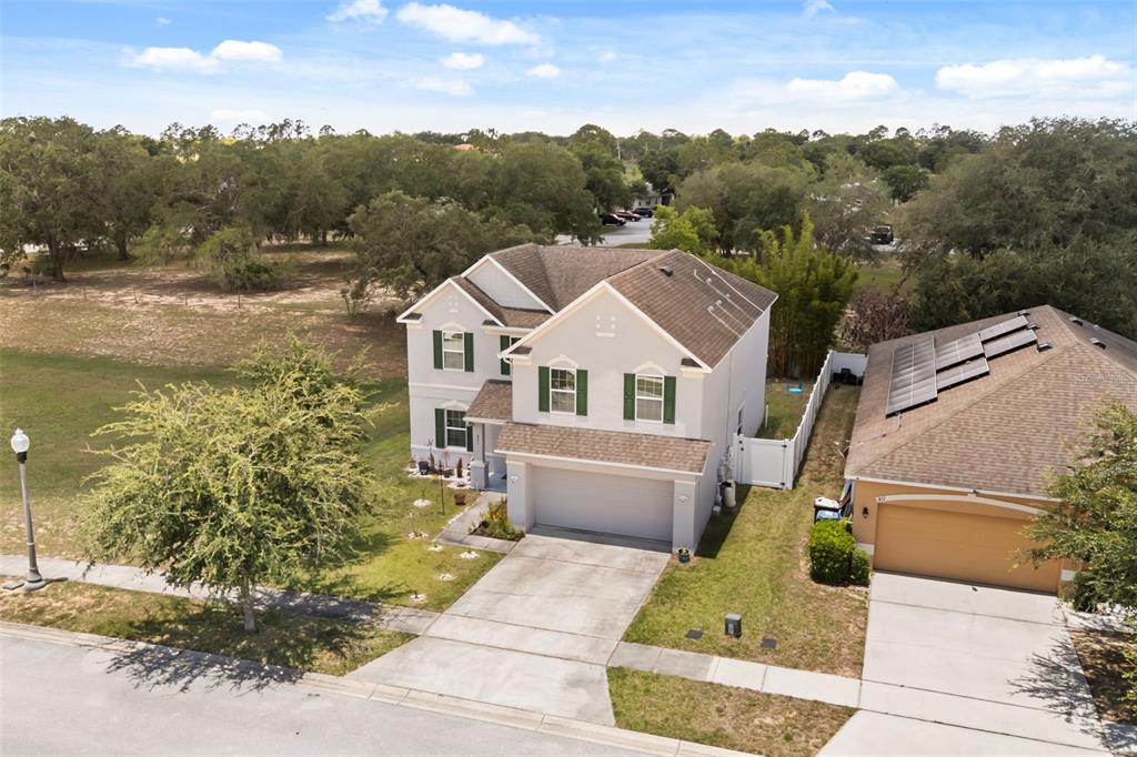 An aerial view shows a two-story suburban house with a garage and green shutters — 841 JEFFERSON BOULEVARD, HAINES CITY, FL