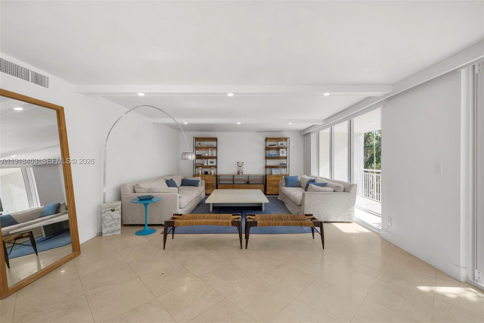 A bright living room features two sofas, a central coffee table, and large floor-to-ceiling windows — 605 Ocean Dr # 2L, Key Biscayne FL 33149, KEY BISCAYNE, FL