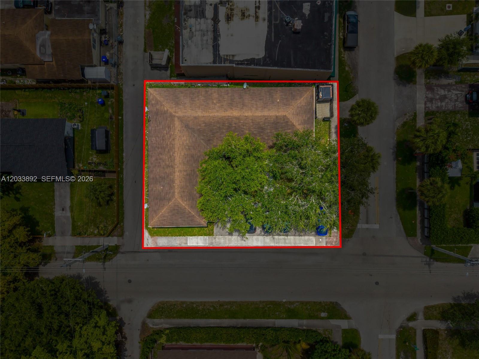 An aerial view shows a building with a brown roof and a large tree — 2247 Simms St, Hollywood FL 33020, HOLLYWOOD, FL