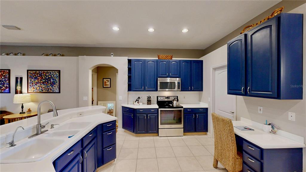 An aerial view shows a suburban house with solar panels installed on its roof — 9101 WOODBRIDGE OAK TERRACE, ORLANDO, FL