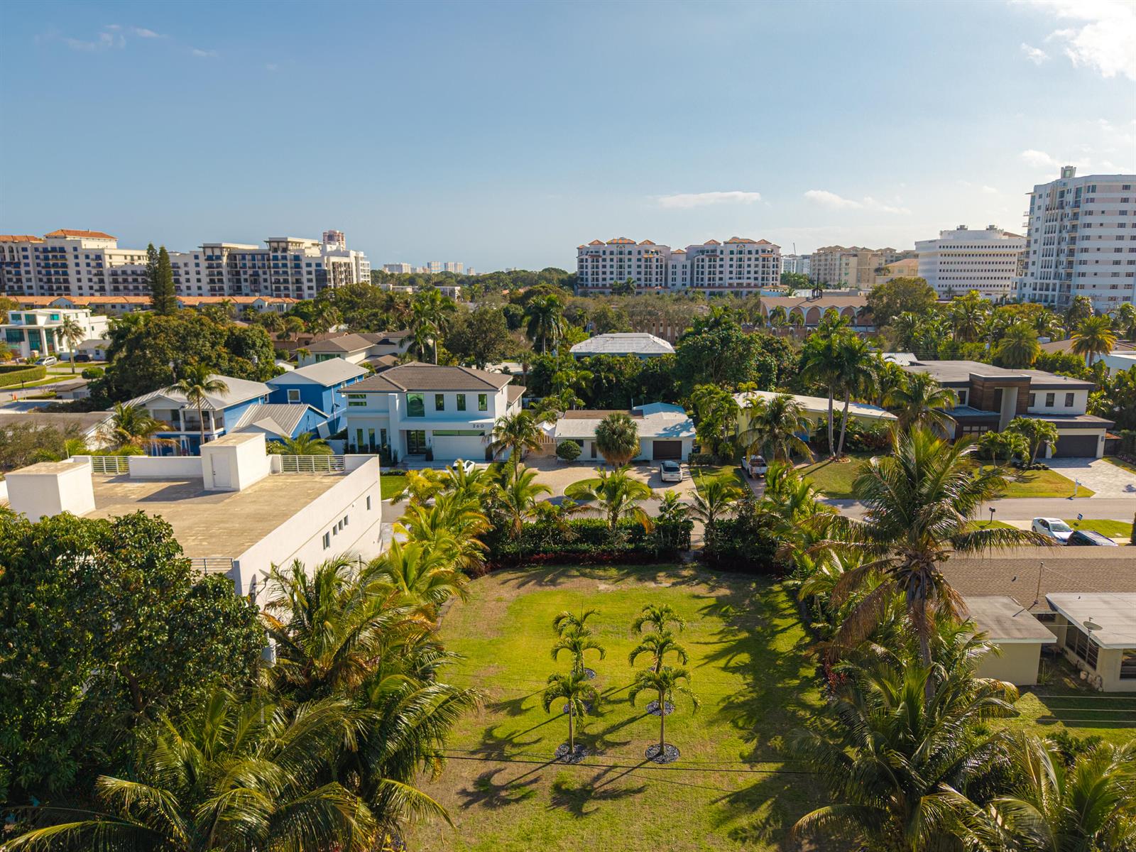 An aerial view shows a grassy lot surrounded by palm trees and residential buildings — 255 NE 3rd Street, Boca Raton FL 33432, BOCA RATON, FL