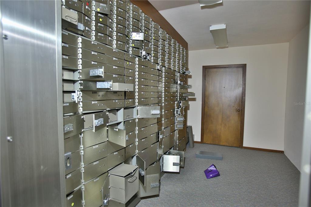 An interior view of a former bank lobby featuring a long wooden teller counter — 5431 E SILVER SPRINGS BOULEVARD UNIT A, SILVER SPRINGS, FL