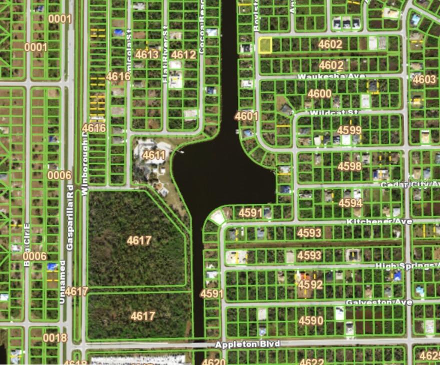 This is a satellite map showing residential lots, streets, and a central canal — 13247 HOLTVILLE AVENUE, PORT CHARLOTTE, FL