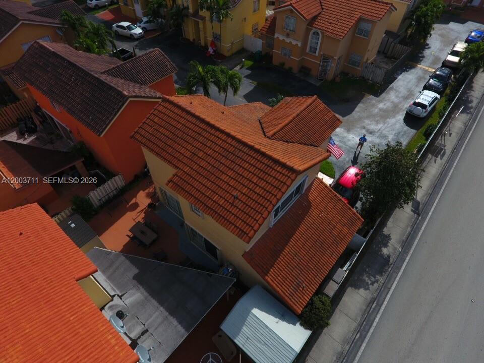 An aerial view shows a two-story house with a red tile roof and a driveway — 12693 NW 9th Ter, Miami FL 33182, MIAMI, FL