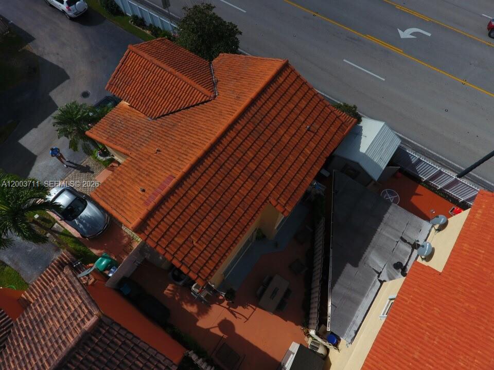 An aerial view shows a house with a terracotta tile roof and a paved patio — 12693 NW 9th Ter, Miami FL 33182, MIAMI, FL