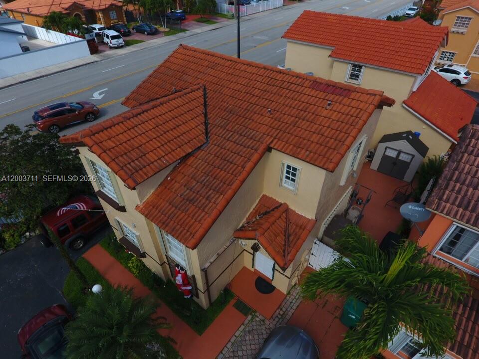An aerial view shows a two-story house with a red tile roof and a driveway — 12693 NW 9th Ter, Miami FL 33182, MIAMI, FL
