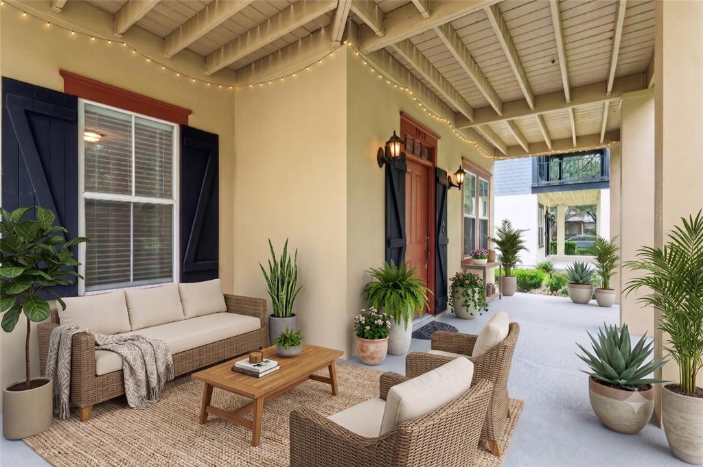 A covered front porch features wicker furniture, potted plants, and string lights — 1017 OLD BLUSH ROAD, KISSIMMEE, FL