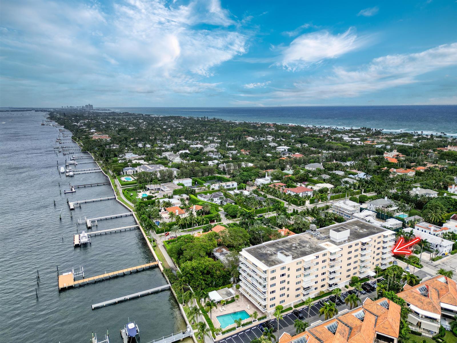 An aerial view shows a multi-story apartment building with a red arrow pointing toward it — 250 N Bradley Place # 402, Palm Beach FL 33480, PALM BEACH, FL