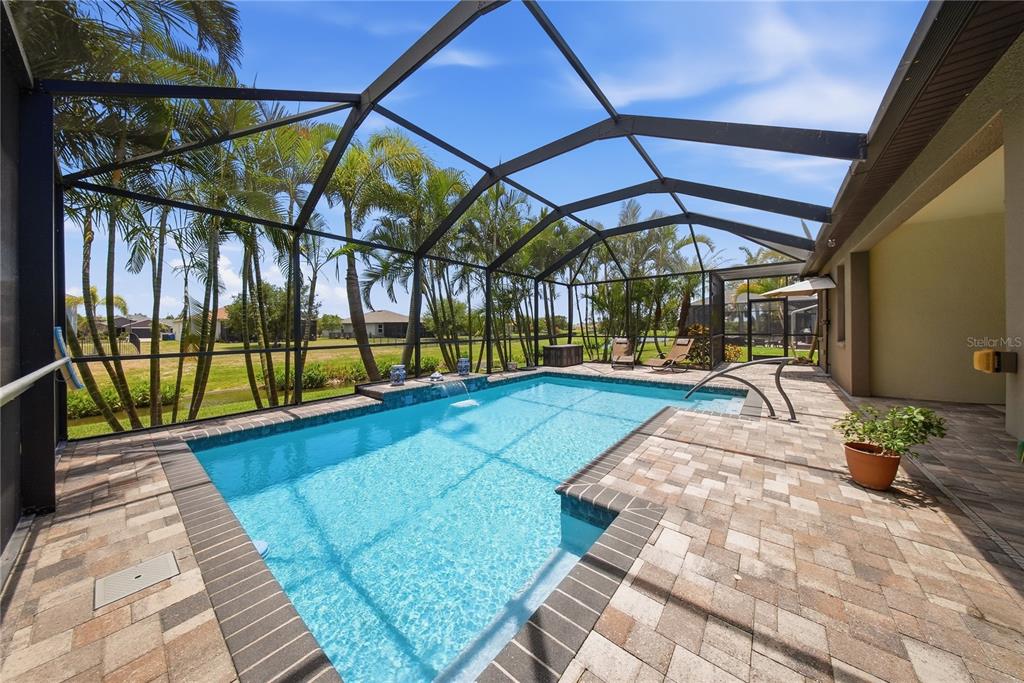 A screened-in swimming pool with a brick paver deck and a view of the backyard — 354 HOPE BAY LOOP, APOLLO BEACH, FL