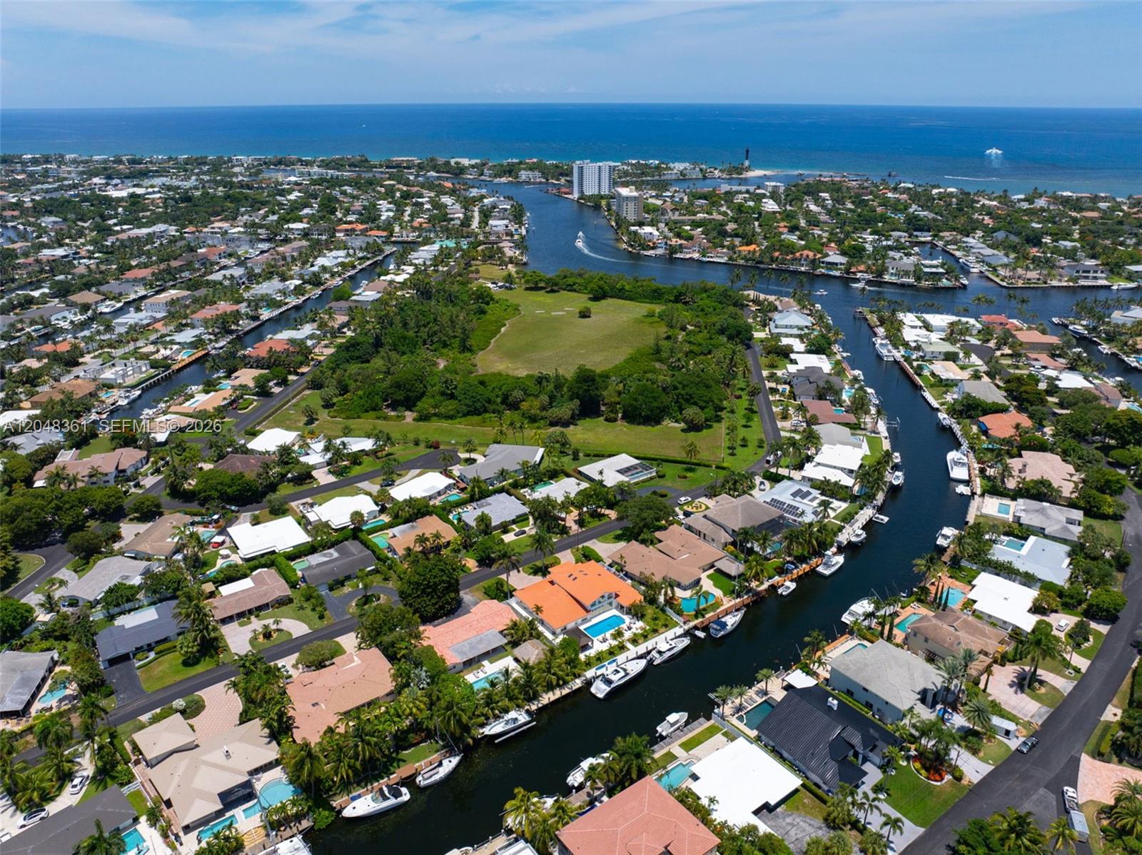 An aerial view shows waterfront homes with private docks along canals near a large park — 2770 NE 23rd Pl, Pompano Beach FL 33062, POMPANO BEACH, FL