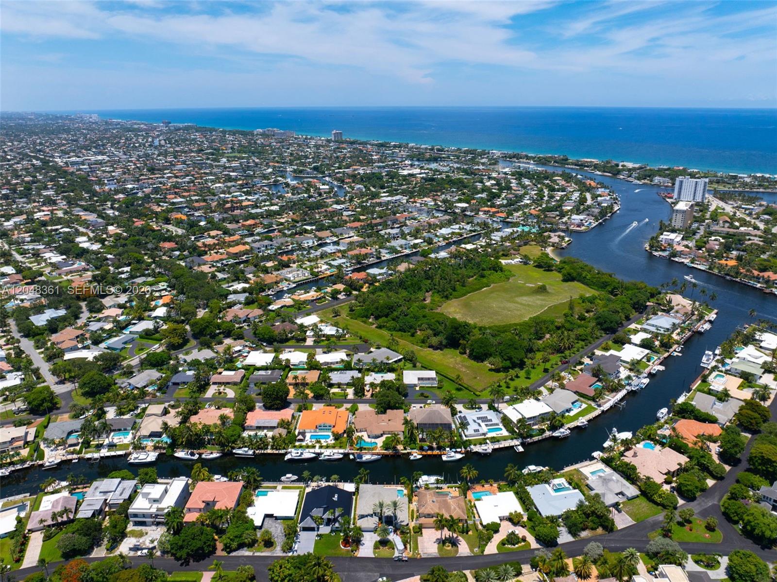 An aerial view shows waterfront homes with private docks along a canal near the ocean — 2770 NE 23rd Pl, Pompano Beach FL 33062, POMPANO BEACH, FL