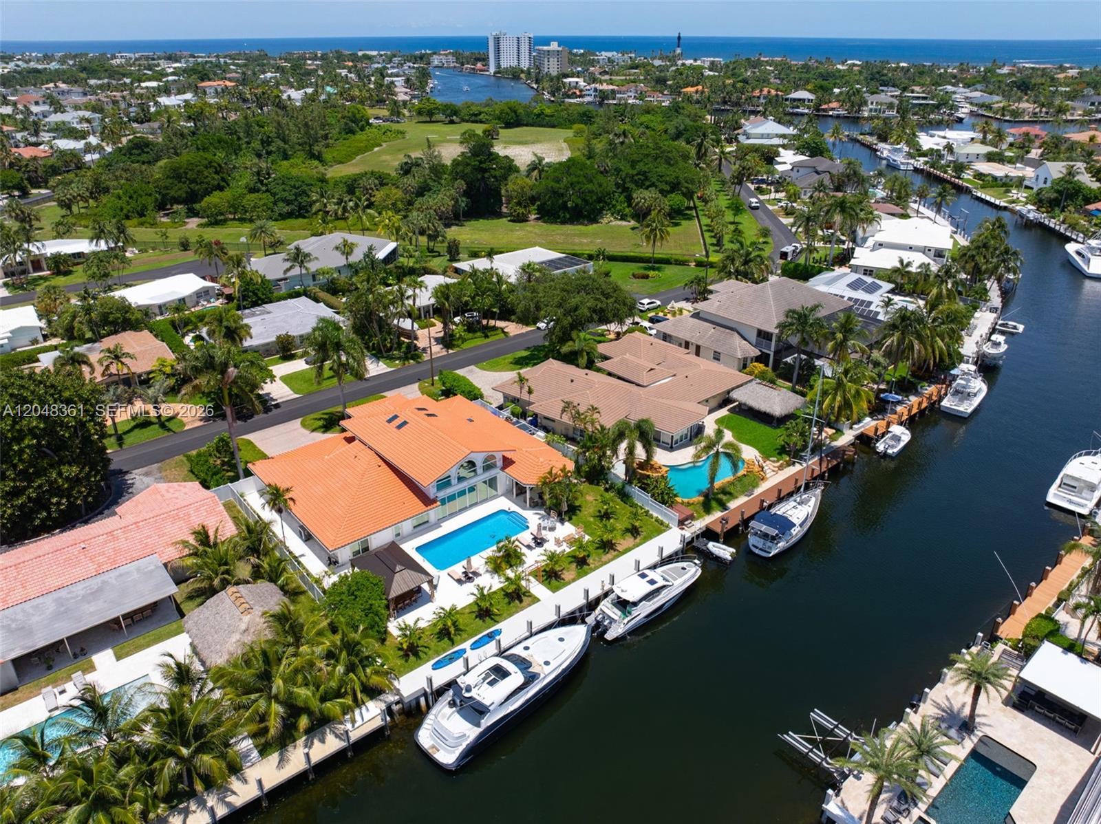An aerial view shows waterfront homes with swimming pools and private docks along a canal — 2770 NE 23rd Pl, Pompano Beach FL 33062, POMPANO BEACH, FL