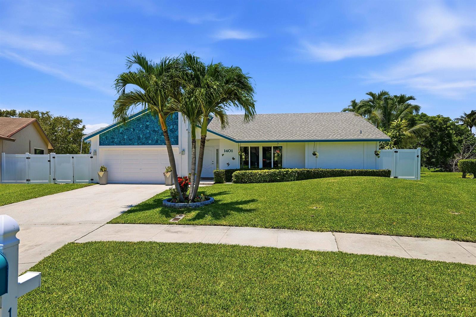 A single-story house with a white exterior, blue stone accent wall, and a palm tree — 1401 SW 28th Terrace, Deerfield Beach FL 33442, DEERFIELD BEACH, FL